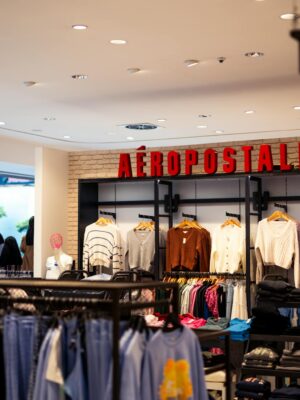 A clothing store with clothes hanging on racks